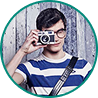 a guy in a striped t-shirt with a camera